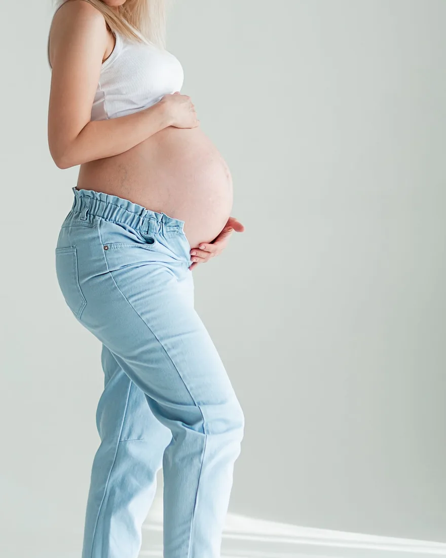 A pregnant woman holding her belly