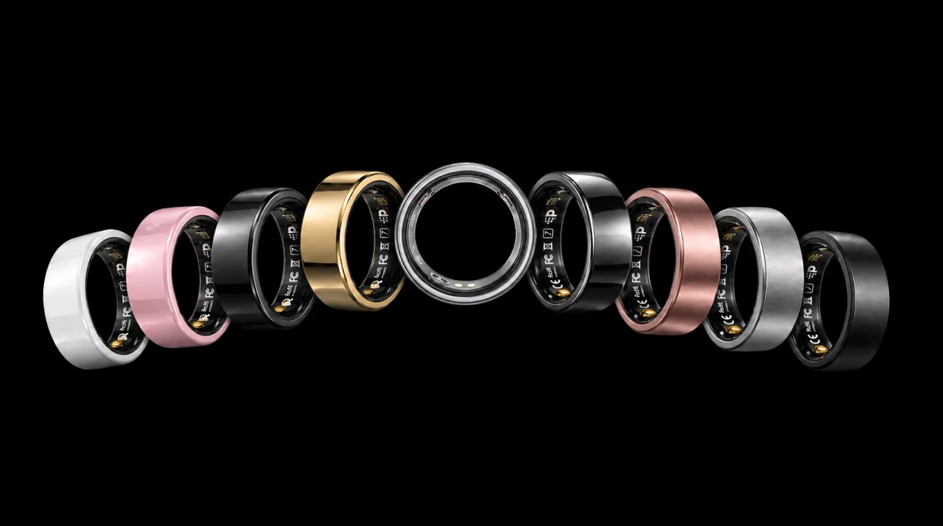 Five PhenomeTech Rings on black in an arc: Ceramic White, Metallic Gold, Brushed Silver facing forward in the centre, Rose Matte and Metallic Black